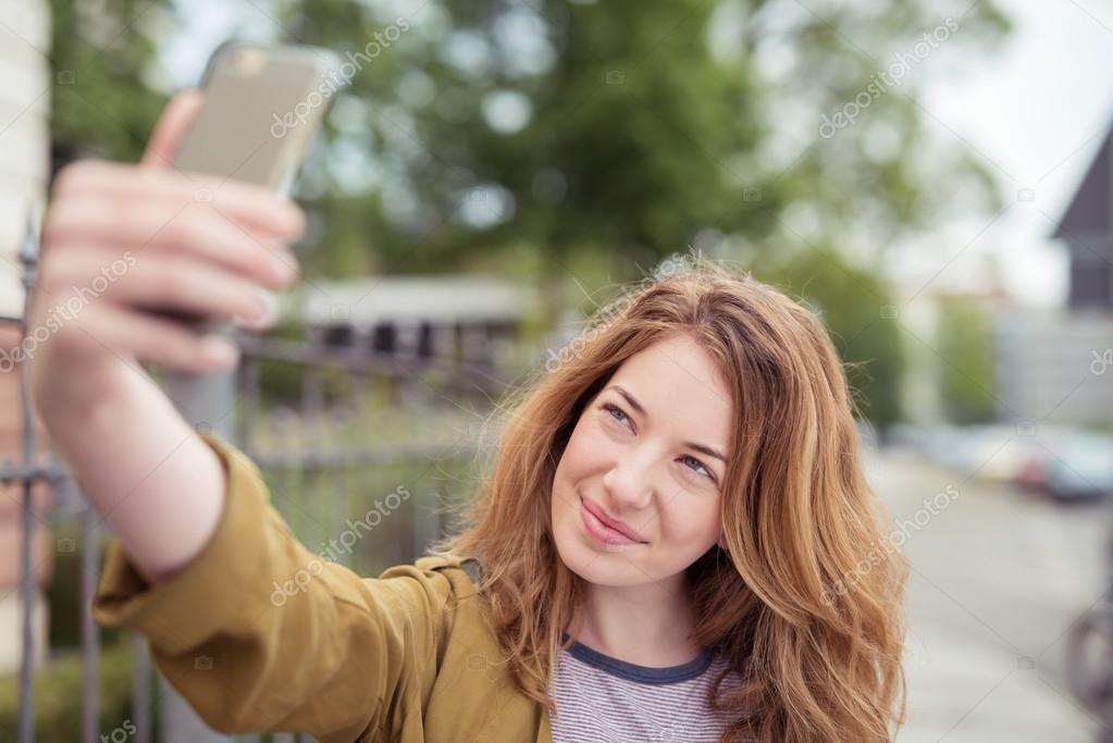 Smiling Teenage Girl Taking A Selfie During A Mountain Hike