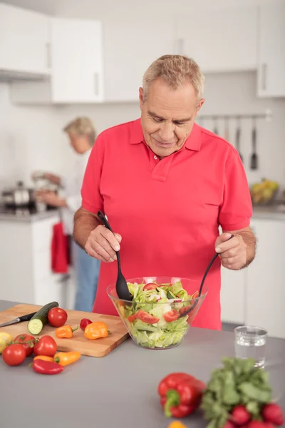 Middle Aged Husband Preparing Fresh Salad — стокове фото