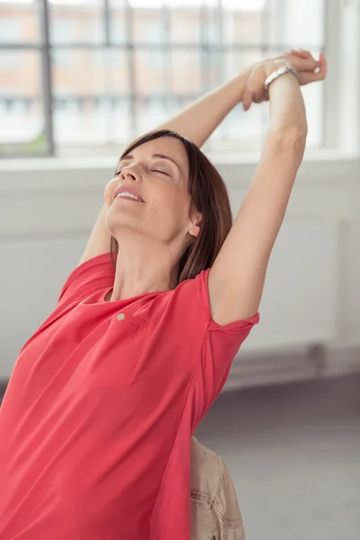 Thoughtful Woman on her Chair Stretching her Arms — ストック写真