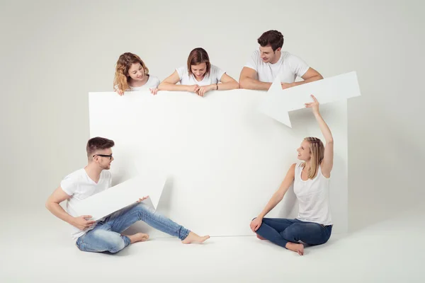 Friends Holding Board and Arrows with Copy Space — Stock Photo, Image