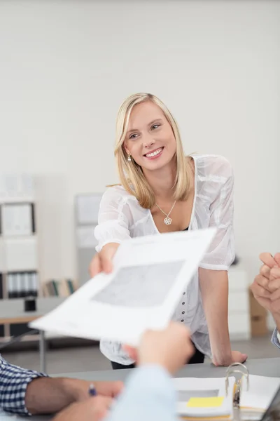 Woman in a Meeting Passing a Document to Co-Worker — Stockfoto