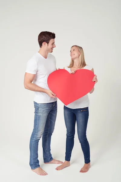 Sweet Couple Holding Red Heart with Copy Space Stock Picture