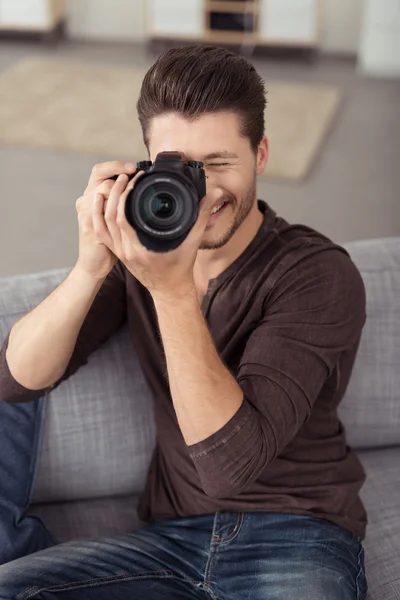 Bonito cara jovem tirando foto com câmera DSLR — Fotografia de Stock