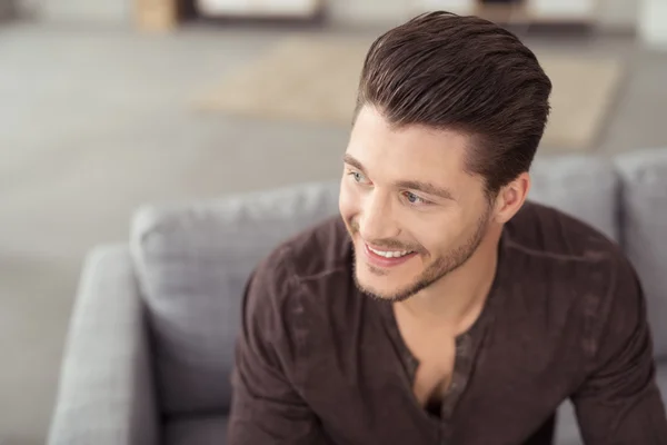 Happy Handsome Young Man Sitting on the Couch — Stock Photo, Image