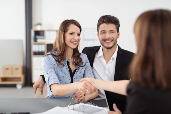 Happy Young Couple Shaking Hands with Realty Agent — Stock Photo, Image