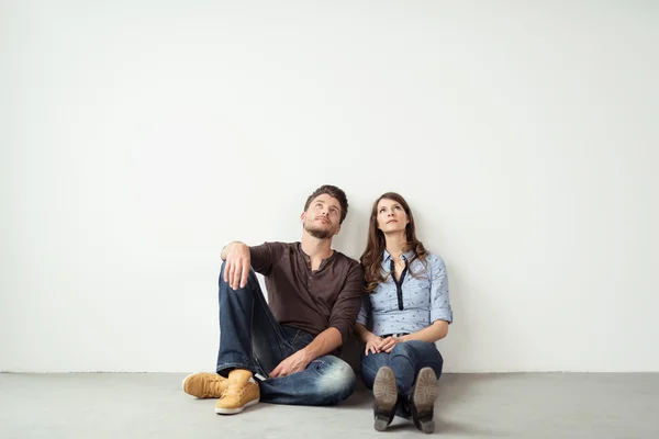 Thoughtful Young Couple Sitting on the Floor — Stock Photo, Image