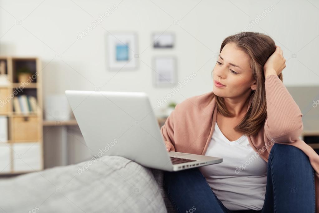 Woman with Laptop Sitting on a Living Room Couch — Stock Photo © racorn ...