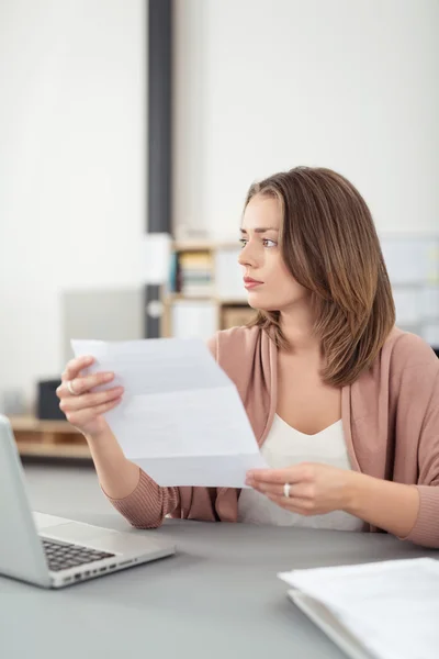 Pensive Office Woman at her Desk Holding a Letter — Stock Photo, Image