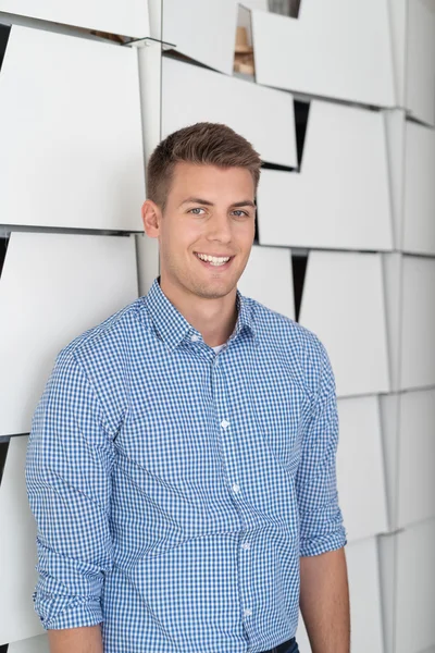 Happy Businessman Leaning Against File Cabinets — Stock Photo, Image