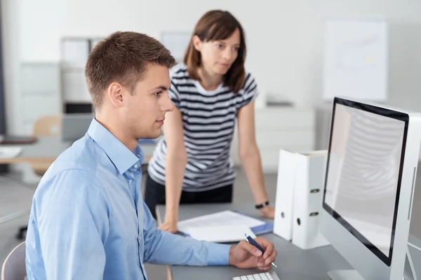 Kantoorpersoneel kijken naar computerscherm samen — Stockfoto