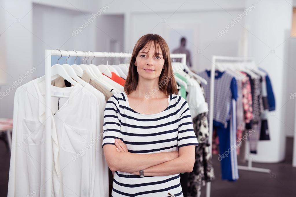 Clothing Store Owner in her Shop Smiles at Camera Stock Photo by