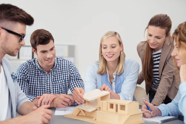 Young Designers Discussing the Miniature on Table — Stock Photo, Image