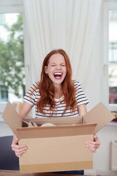 Attractive young woman enjoying a hearty laugh — Stok fotoğraf