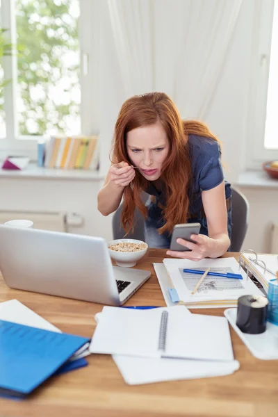 Woman at Home Office Eating While Busy with Phone — 스톡 사진