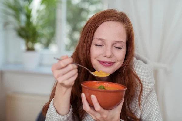 Nachdenkliche junge Frau isst zu Hause Suppe — Stockfoto