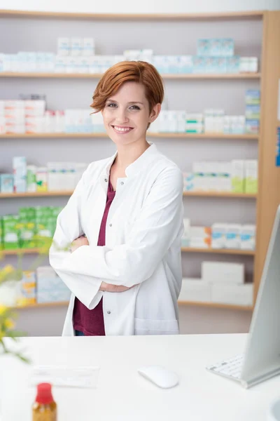 Attractive friendly young female pharmacist — Stock fotografie