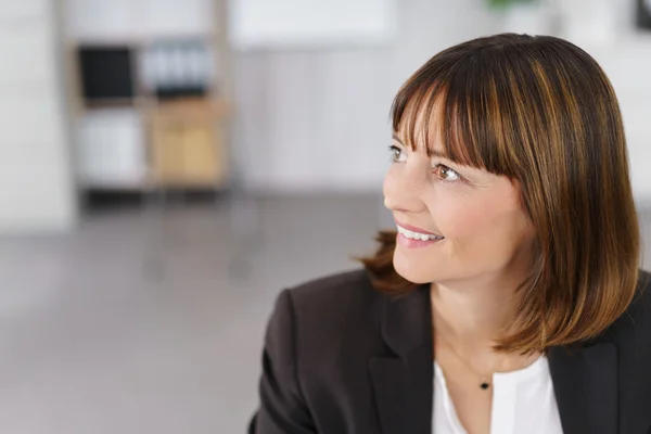 Thoughtful Businesswoman Smiling Into the Distance — Stock Photo, Image