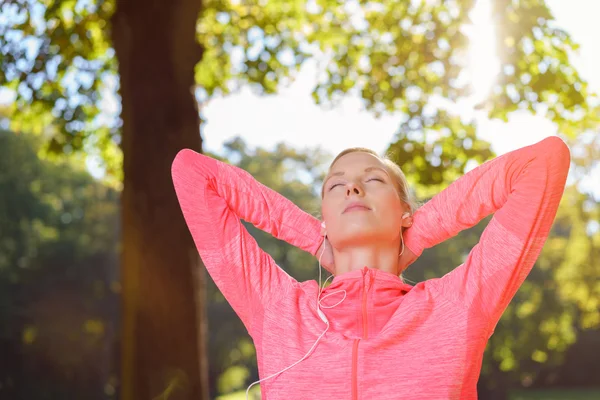 Thoughtful Woman Listens to Music using Earphones — 스톡 사진