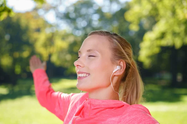 Thoughtful Girl Listening to Music Using Earphones — Stock fotografie