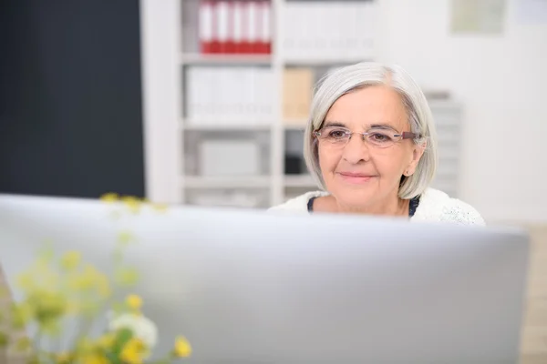 Senior Businesswoman en su Mirando el Monitor —  Fotos de Stock