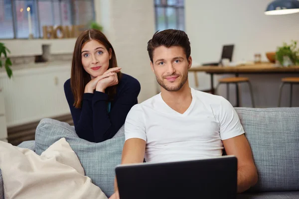 Casual young couple relaxing on the sofa — Stock Photo, Image
