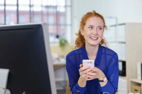 Gelukkig jonge kantoor werknemer met behulp van een mobiele — Stockfoto