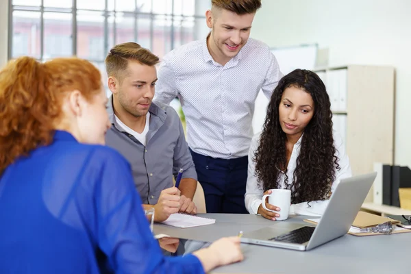 Four Business People Watching Something on Laptop — Zdjęcie stockowe