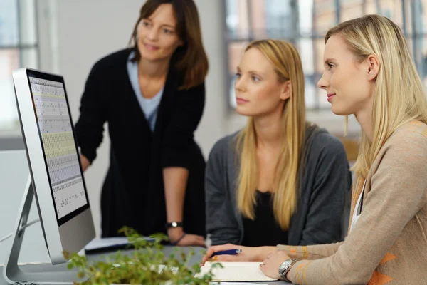 Three Office Women Looking at Computer Together — Stockfoto