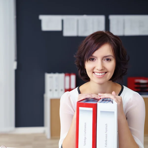 Smiling Office Woman Holding Binders on the Table — Stok fotoğraf