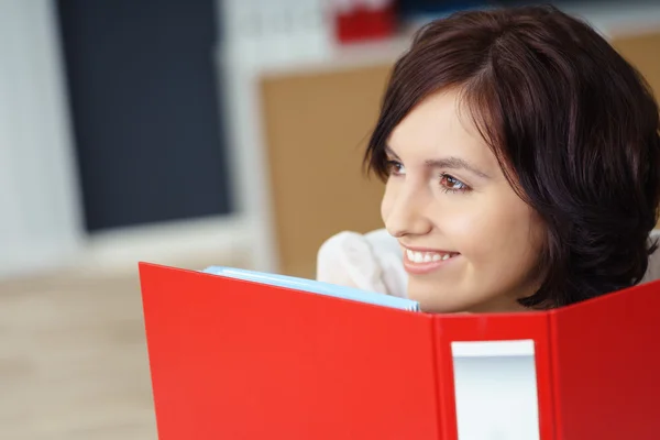 Thoughtful Woman with File Binder Looking Away — Zdjęcie stockowe