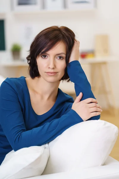 Woman on White Sofa, Leaning Head Against Hand — ストック写真