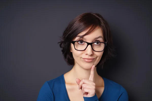 Thoughtful Woman with Finger on Face Against Gray — Stock Photo, Image