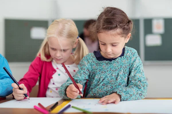 Two cute young girls in primary school — Stock Photo, Image