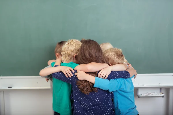 Group of young school friends in a huddle — Stock Photo, Image