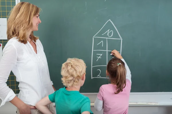 Young schoolgirl doing simple arithmetic — Stok fotoğraf