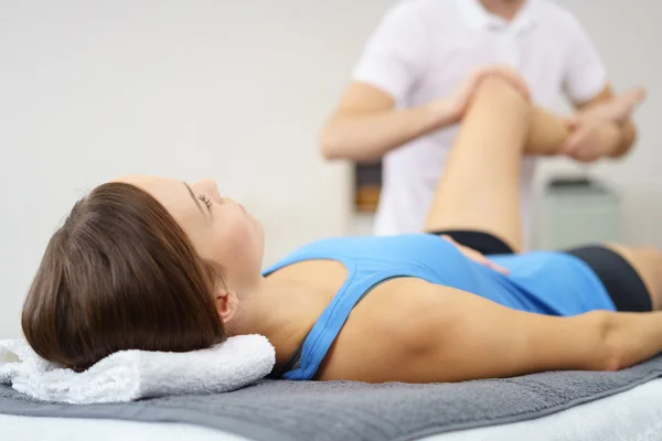 Injured Woman Lying on a Therapy Bed for Massage — Stock Photo, Image