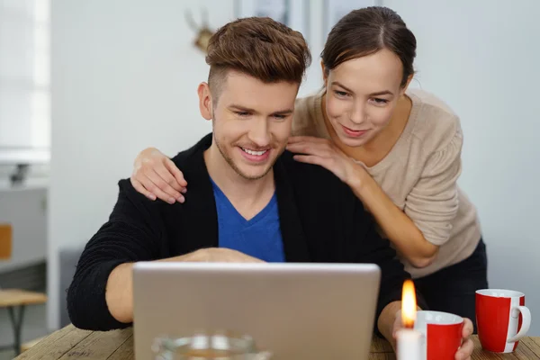 Loving couple looking at notebook — Stock Photo, Image