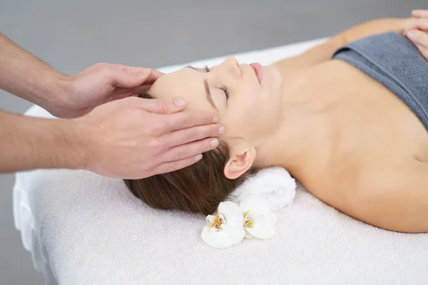 Attractive young Woman enjoying a head massage — Stock Photo, Image