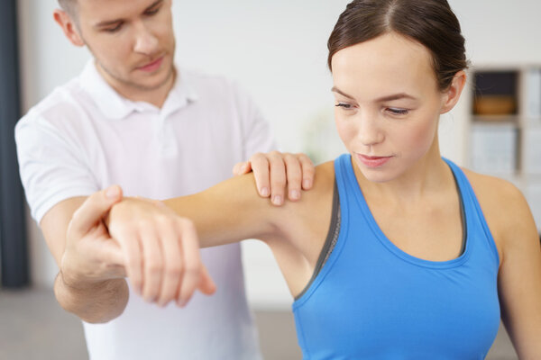 Physical Therapist Helping Patient in Exercise Stock Picture