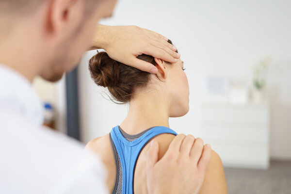 Physical Therapist Stretching the Neck of Patient Stock Picture