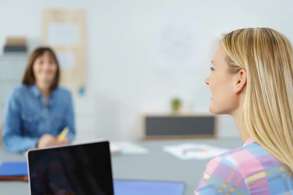 Mujer de oficina hablando con su colega en el lugar de trabajo — Foto de Stock