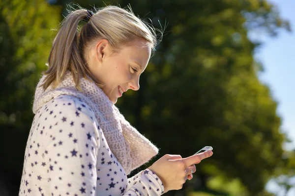 Happy young woman reading good news — Stock Photo, Image