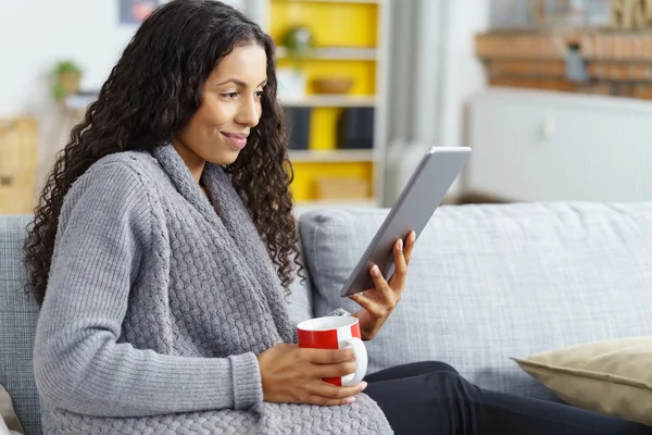 woman reading on tablet at home