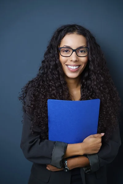 woman with spectacles clutching a blue CV