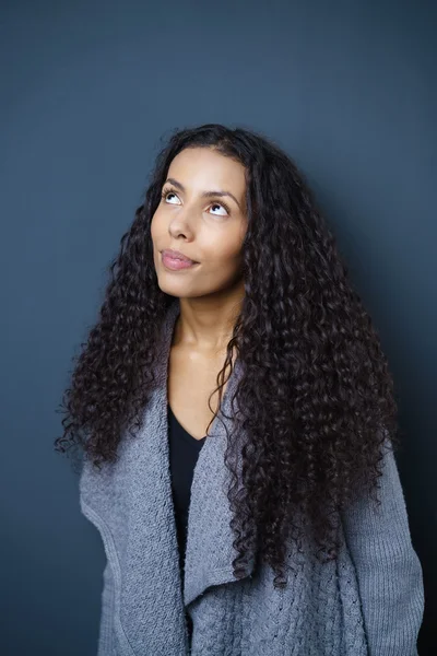 Pretty young African American woman daydreaming — ストック写真