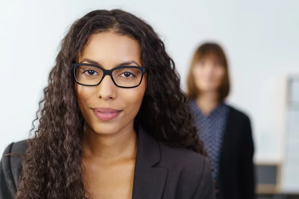Grinning office worker with eyeglasses