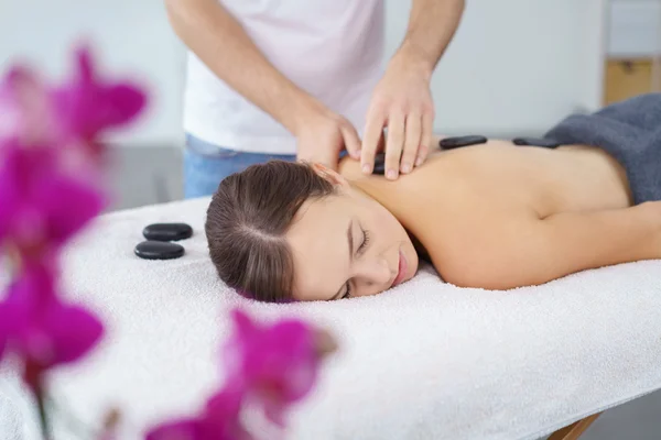 Caldo pietra massaggio donna godere di spa trattamento — Foto Stock