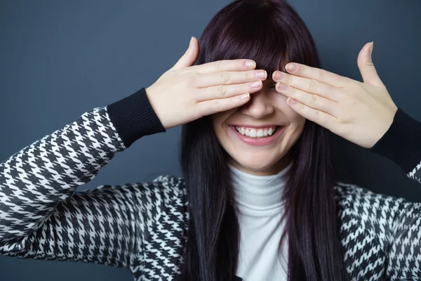Παιχνιδιάρικο νεαρή γυναίκα που καλύπτουν τα μάτια με τα χέρια — Φωτογραφία Αρχείου