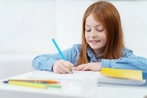 Creative little girl drawing with a colored pencil — Stock Photo, Image