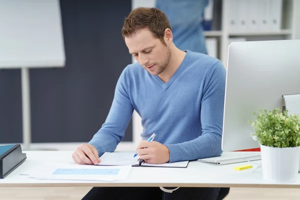 Empresário fazendo papelada no escritório — Fotografia de Stock